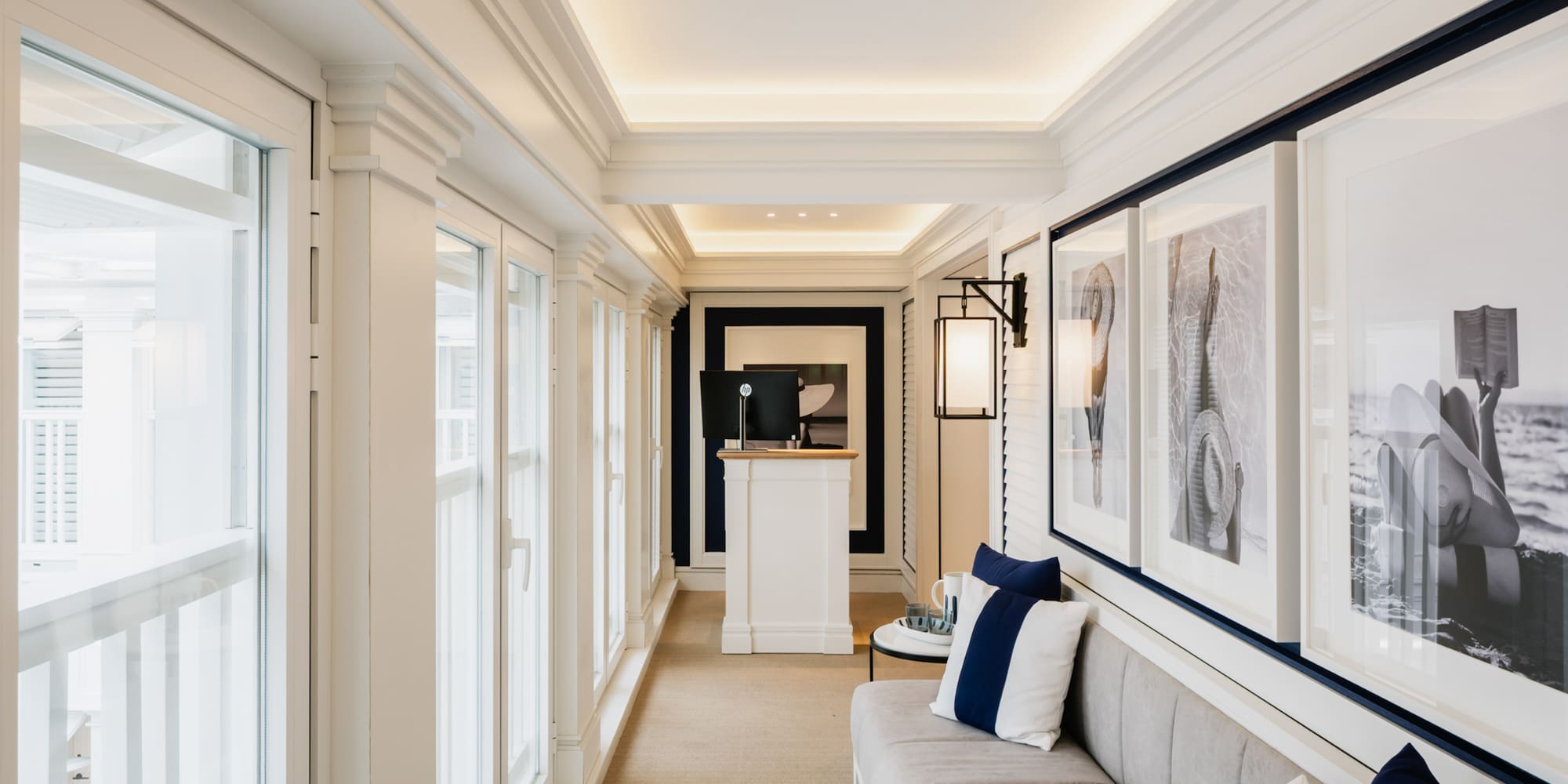 a long hallway with a couch and art on the wall