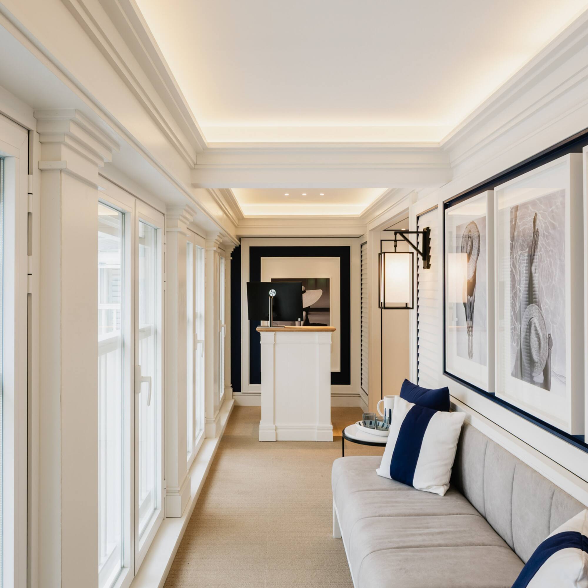 a long hallway with a couch and art on the wall