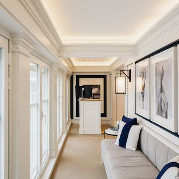 a long hallway with a couch and art on the wall