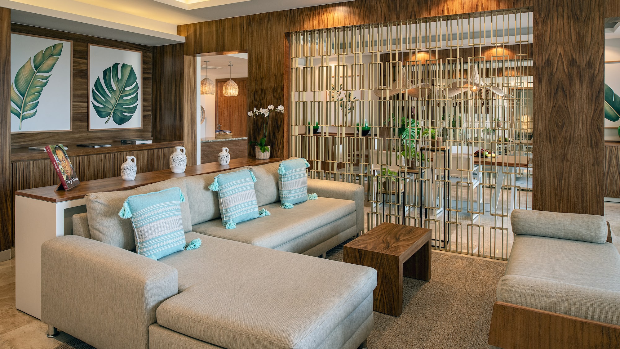 a living room with a large couch and a glass partition