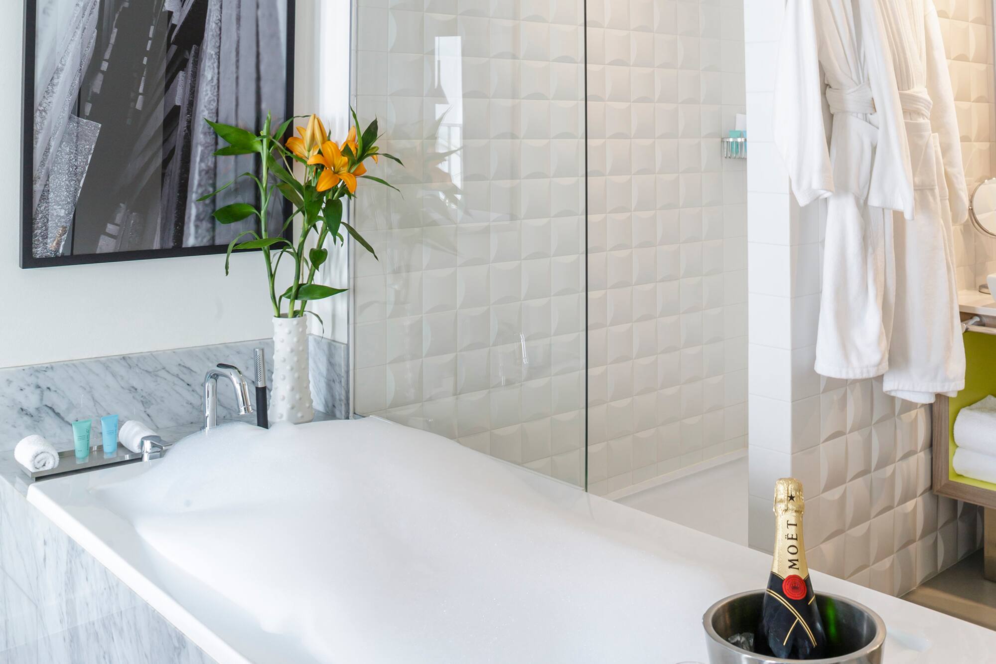 a bathtub with champagne in it and a glass shower door