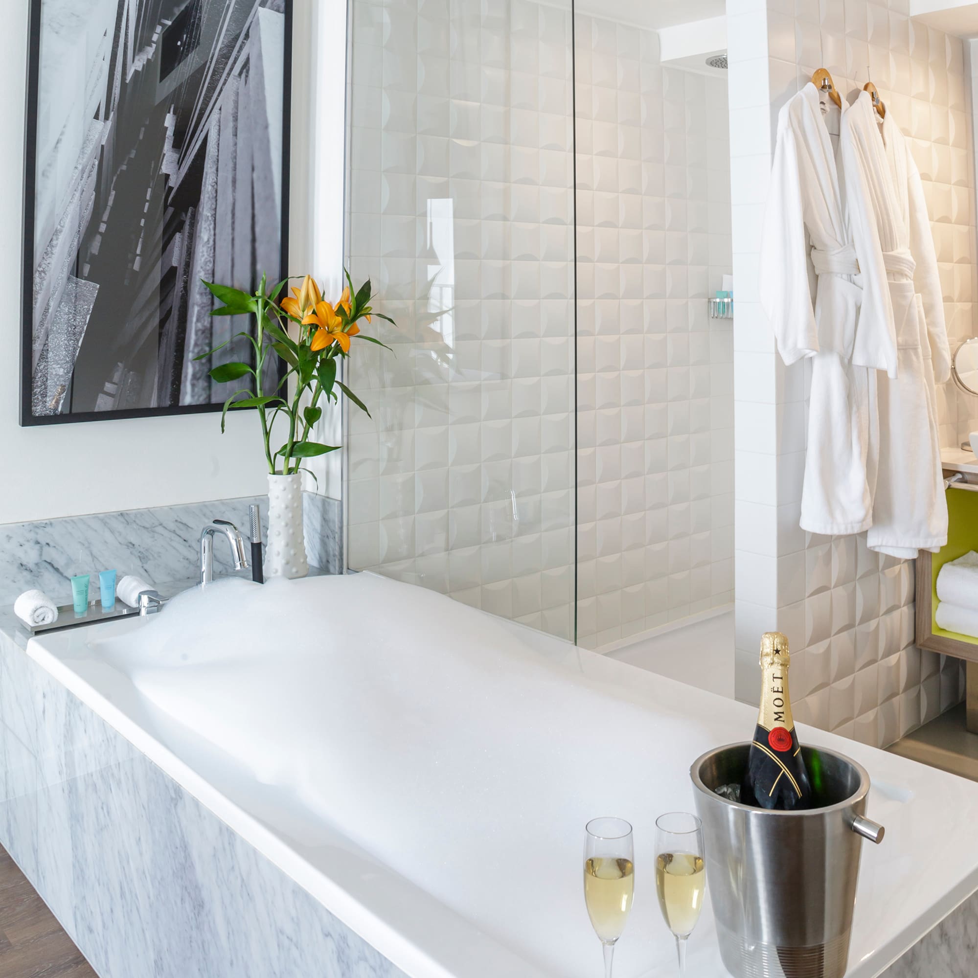 a bathtub with champagne in it and a glass shower door