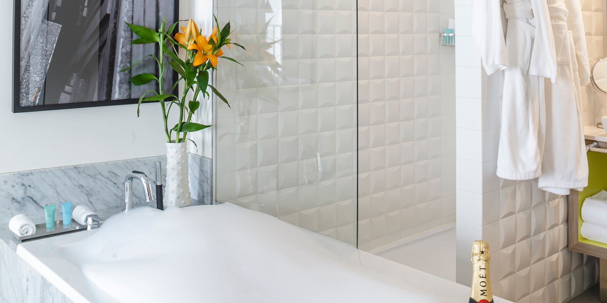 a bathtub with champagne in it and a glass shower door