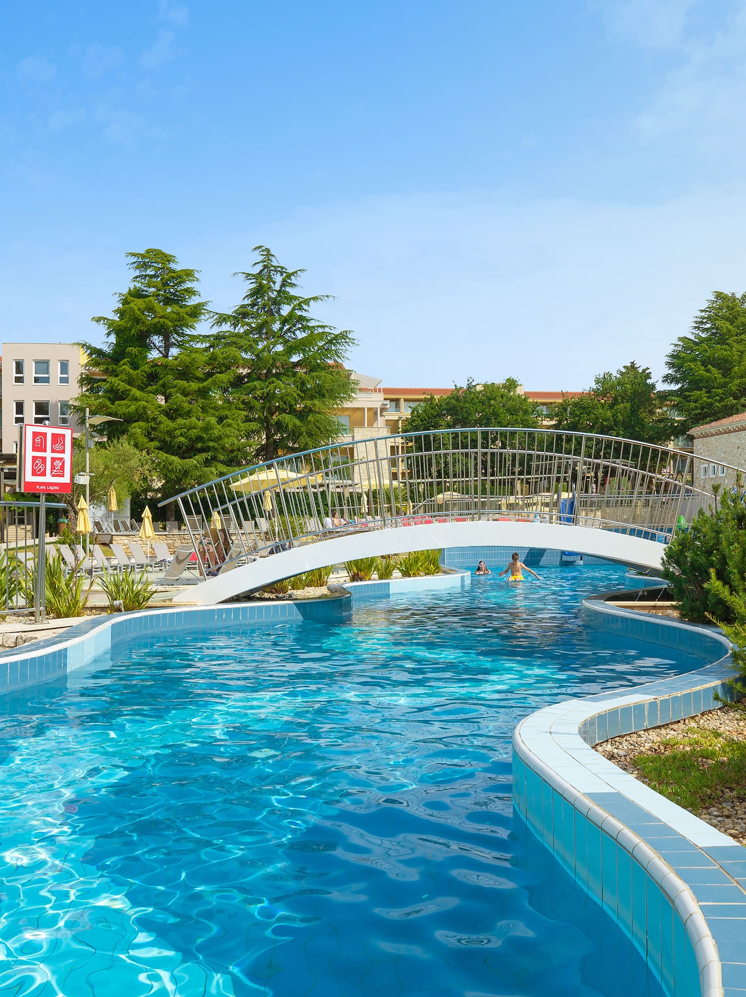 a swimming pool with a bridge over it