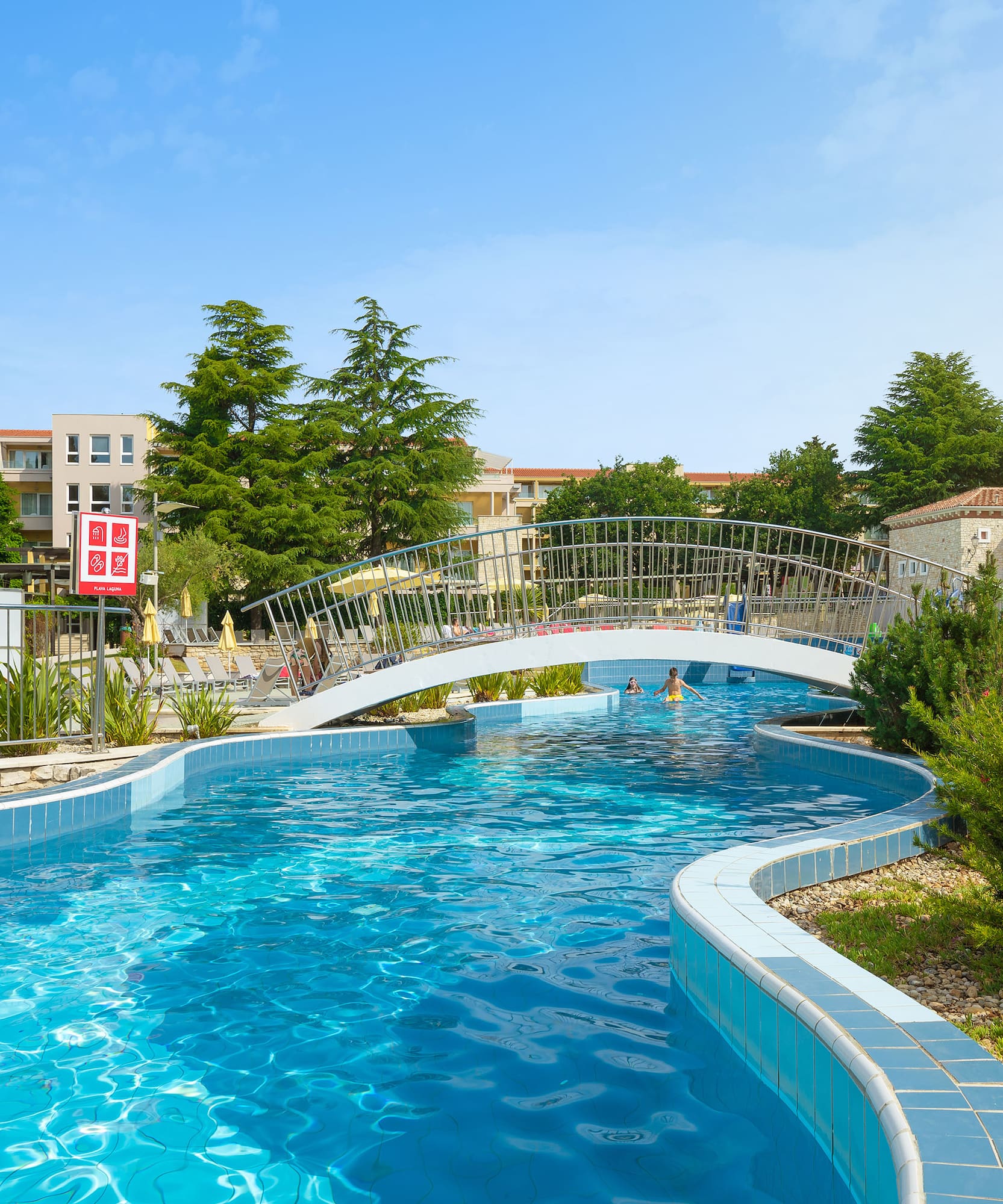 a swimming pool with a bridge over it