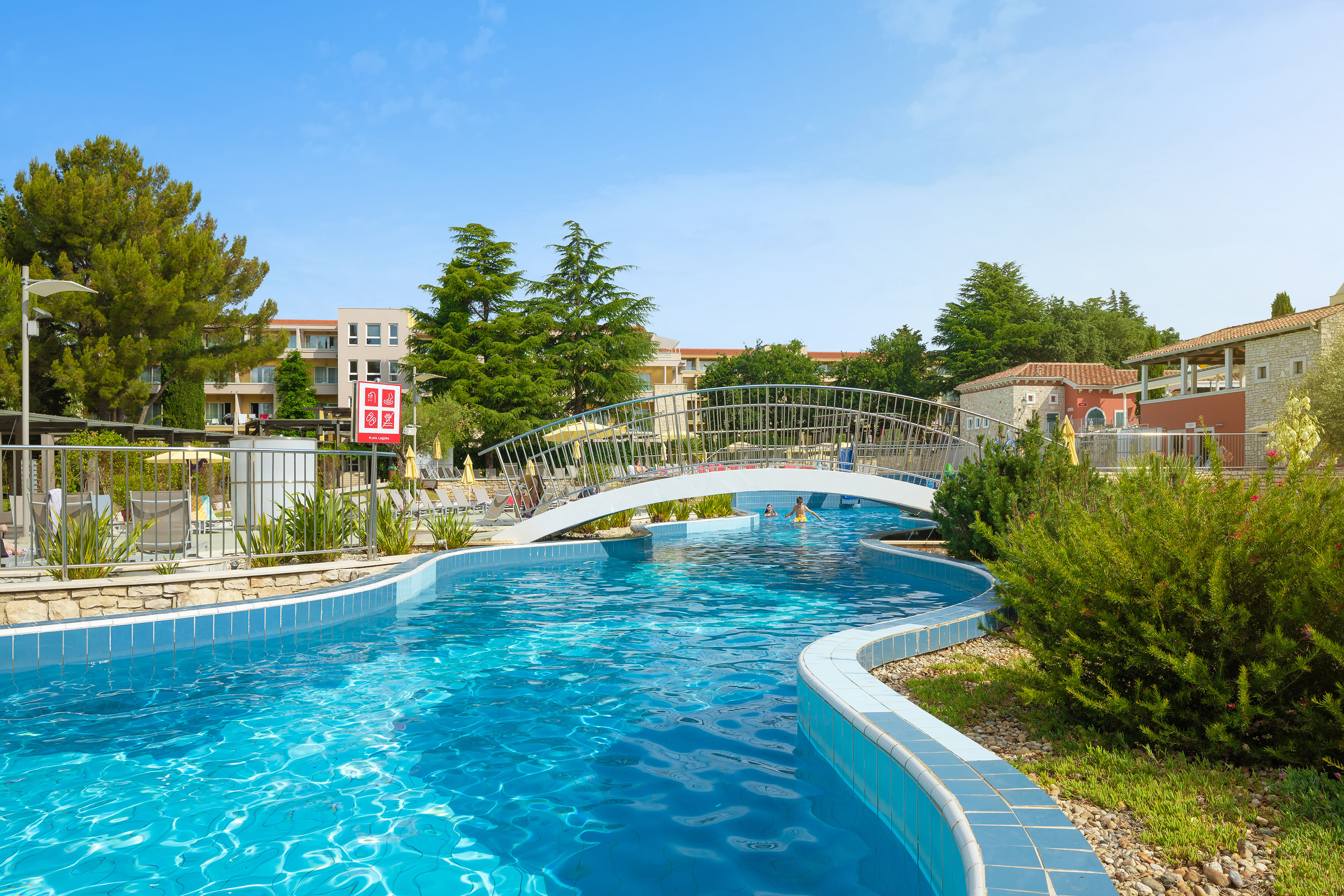 a swimming pool with a bridge over it