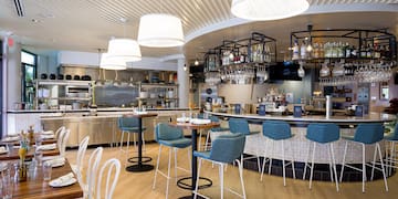 a restaurant with a bar and chairs