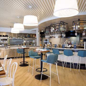 a restaurant with a bar and chairs