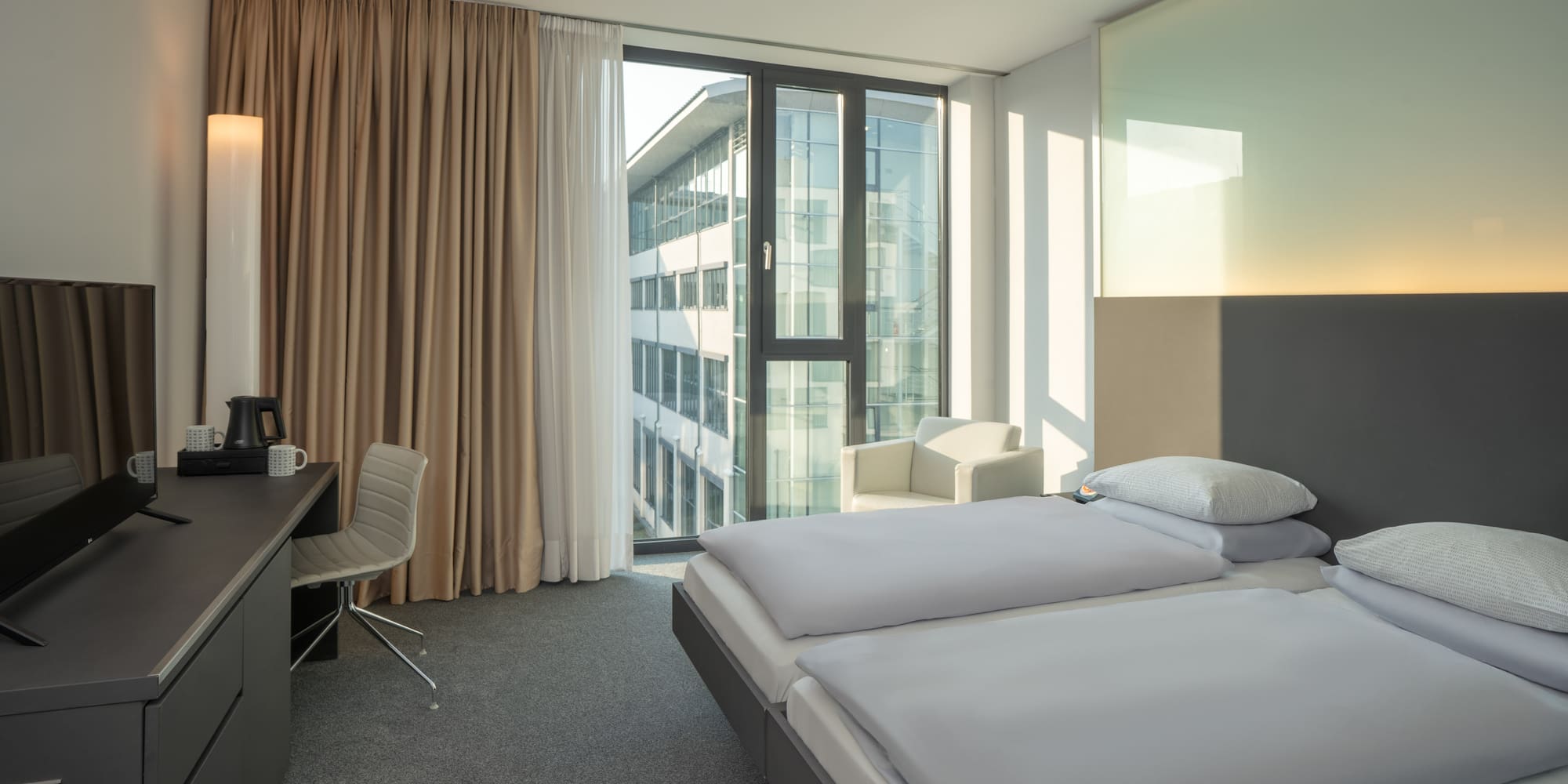 a room with two beds and a desk