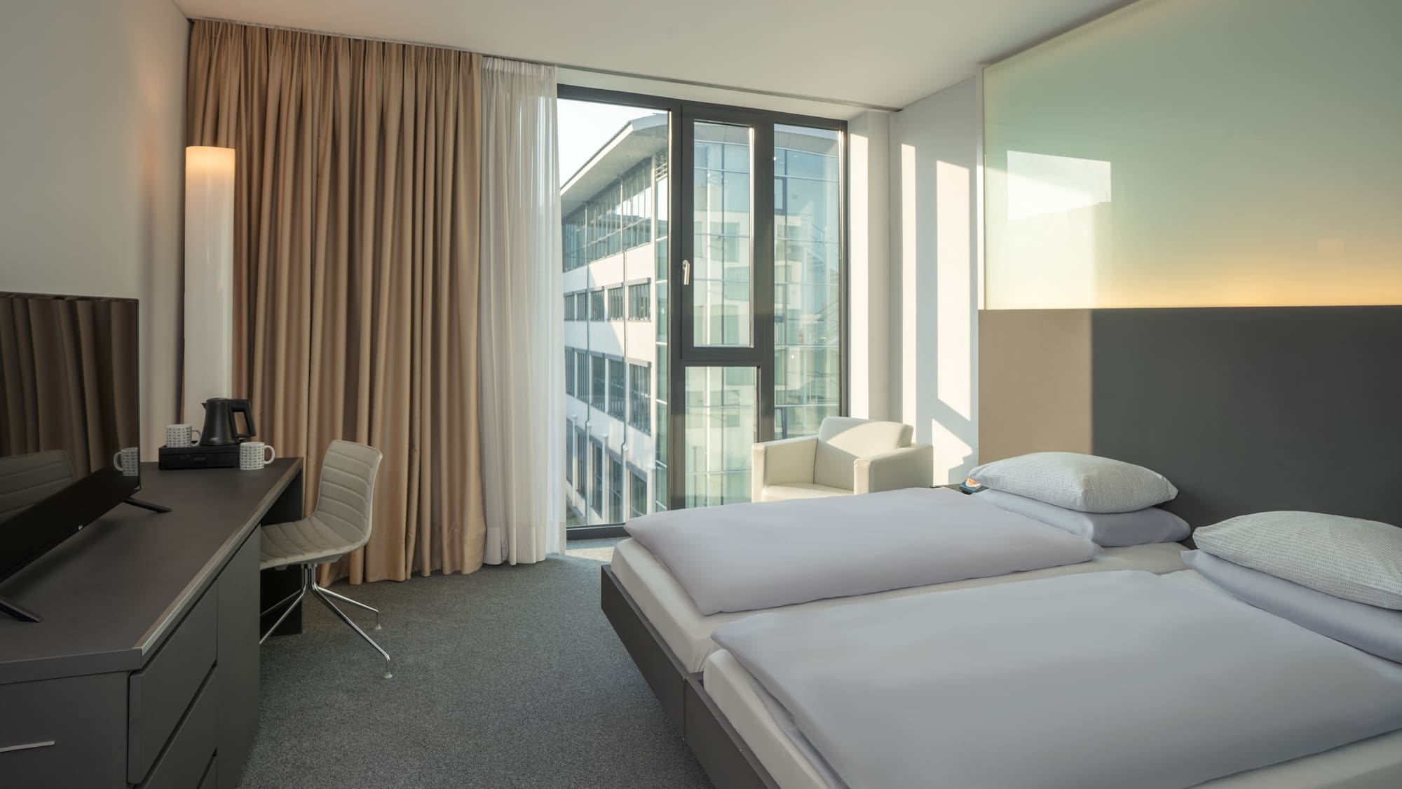 a room with two beds and a desk