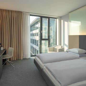 a room with two beds and a desk