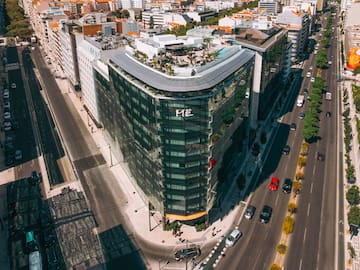 a rooftop of a building with a large city in the background