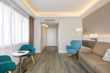 a room with a couch and chairs
