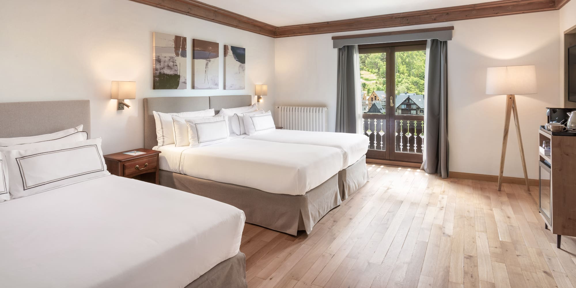 a room with two beds and a television