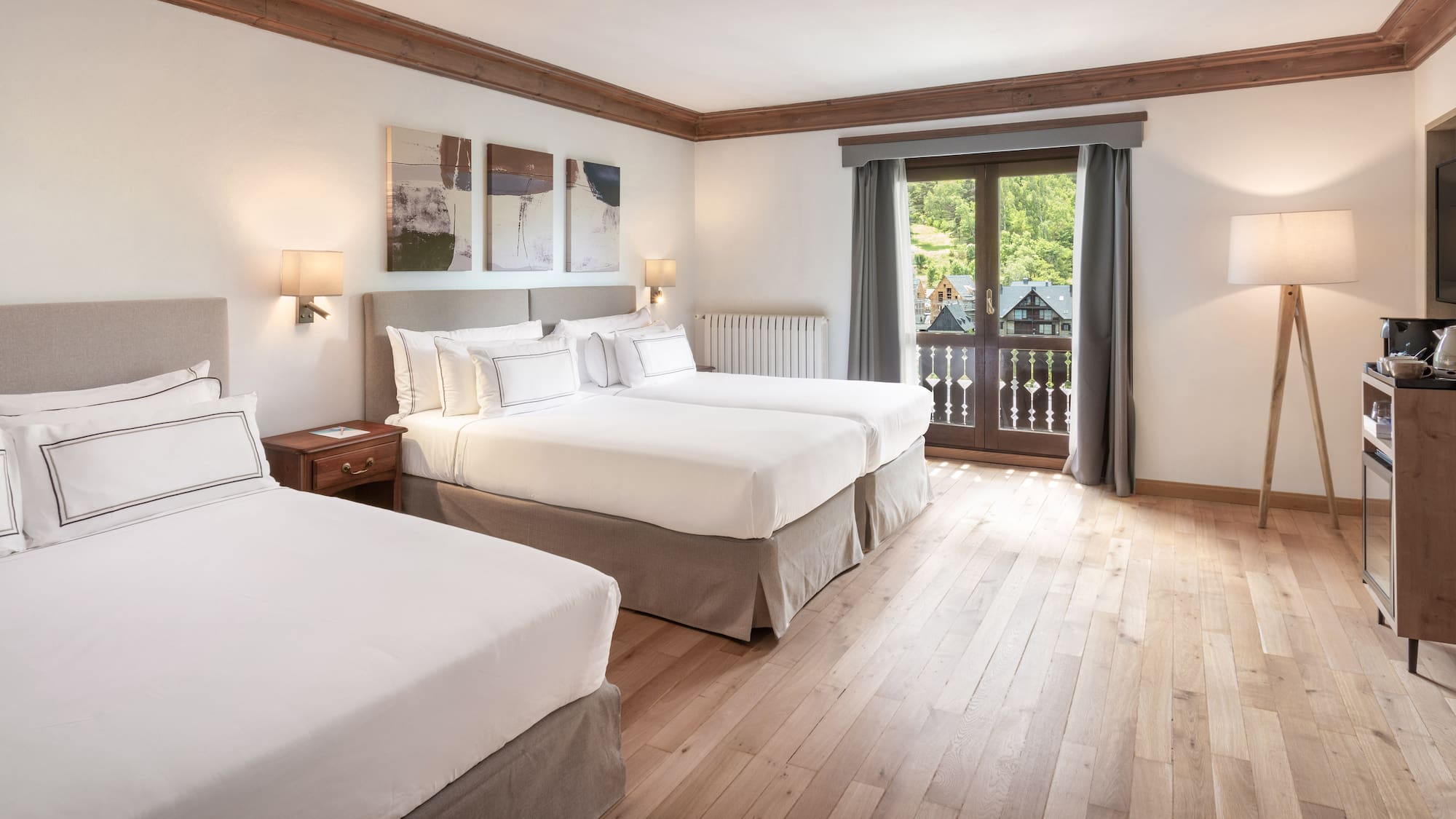 a room with two beds and a window