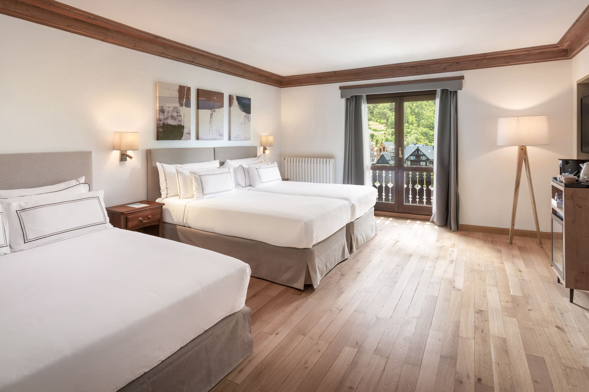 a room with two beds and a television