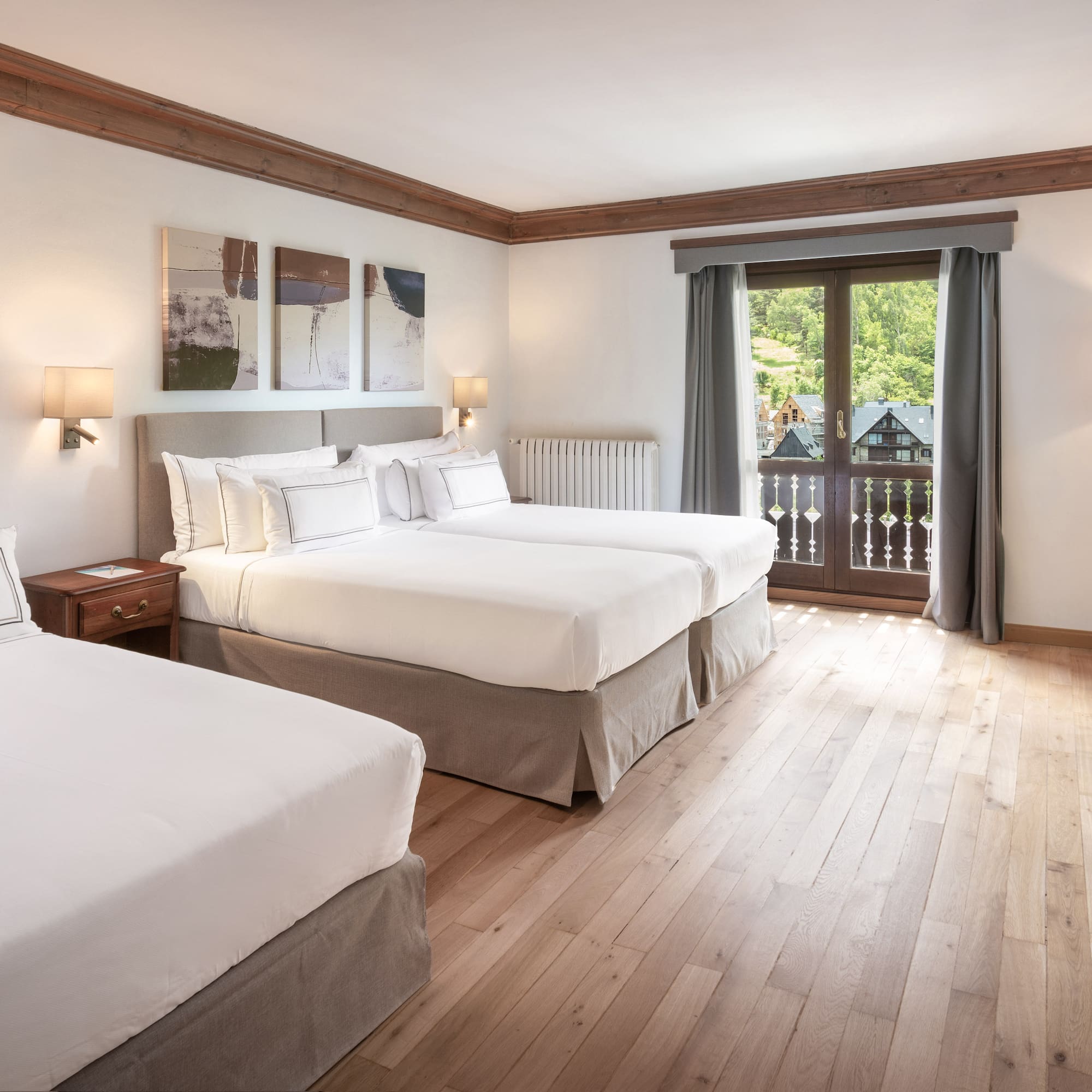 a room with two beds and a television