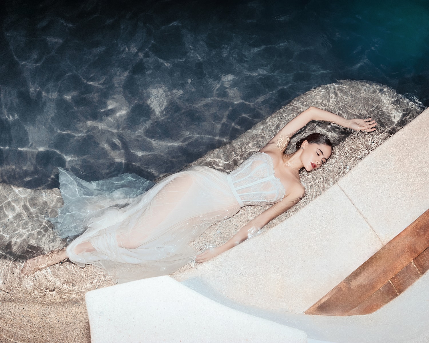 a woman lying in a pool