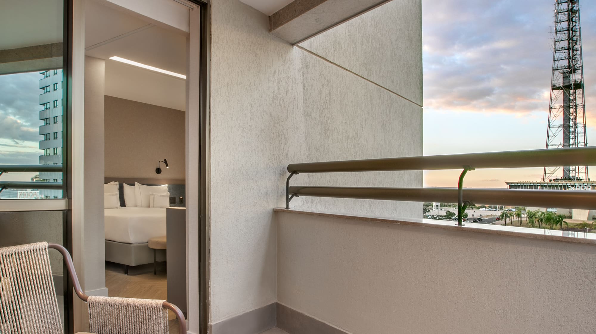 a balcony with chairs and a table