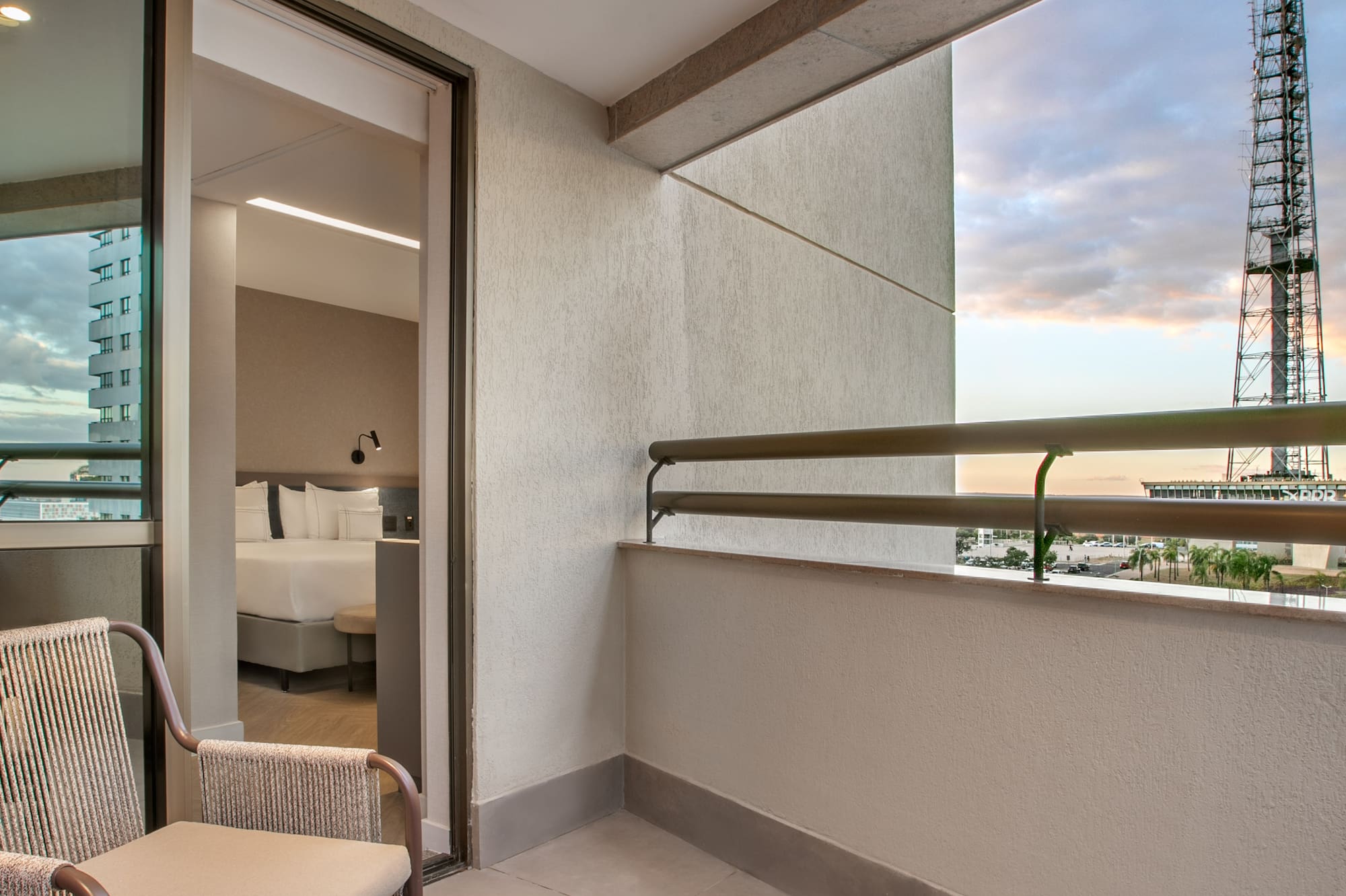 a balcony with chairs and a table