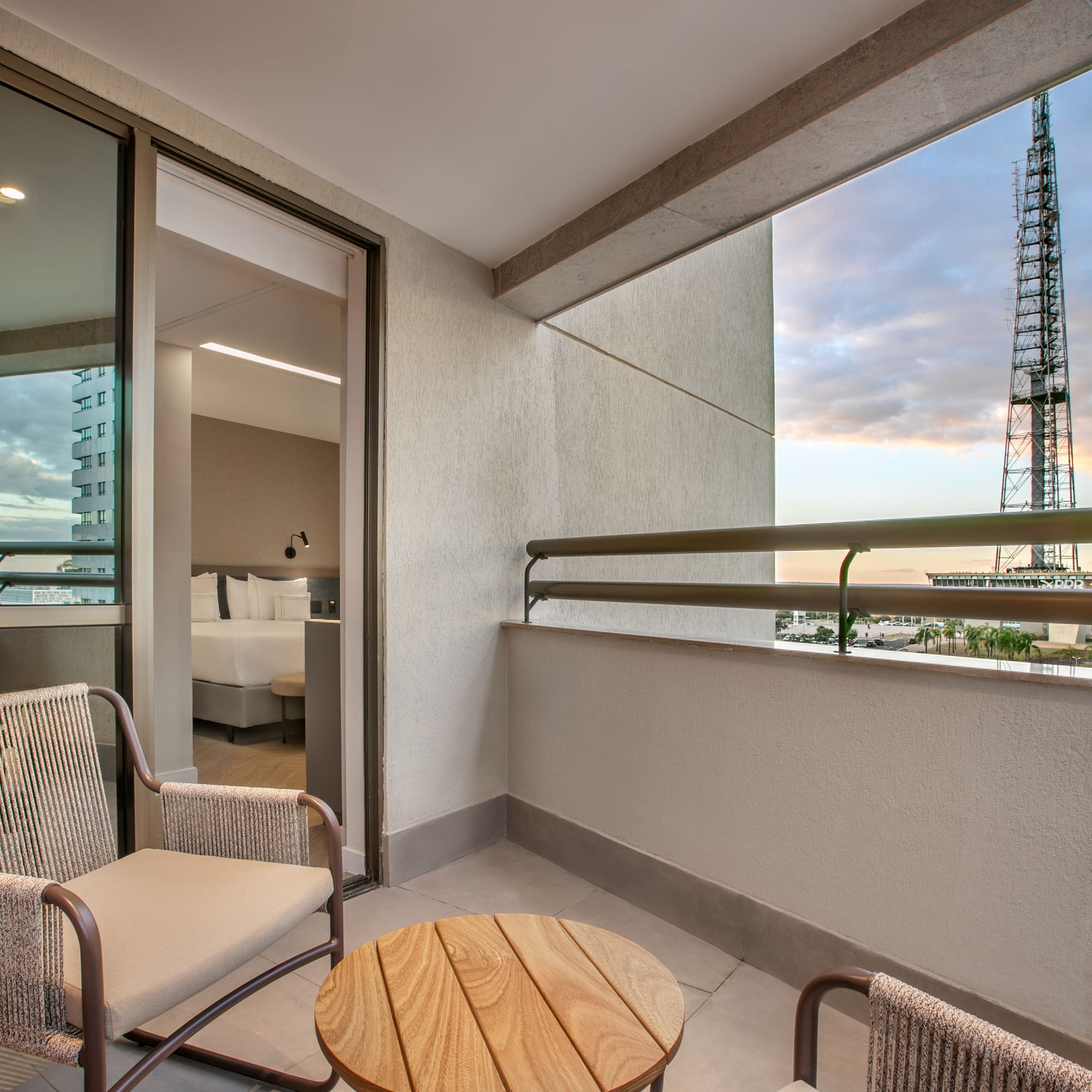 a balcony with chairs and a table