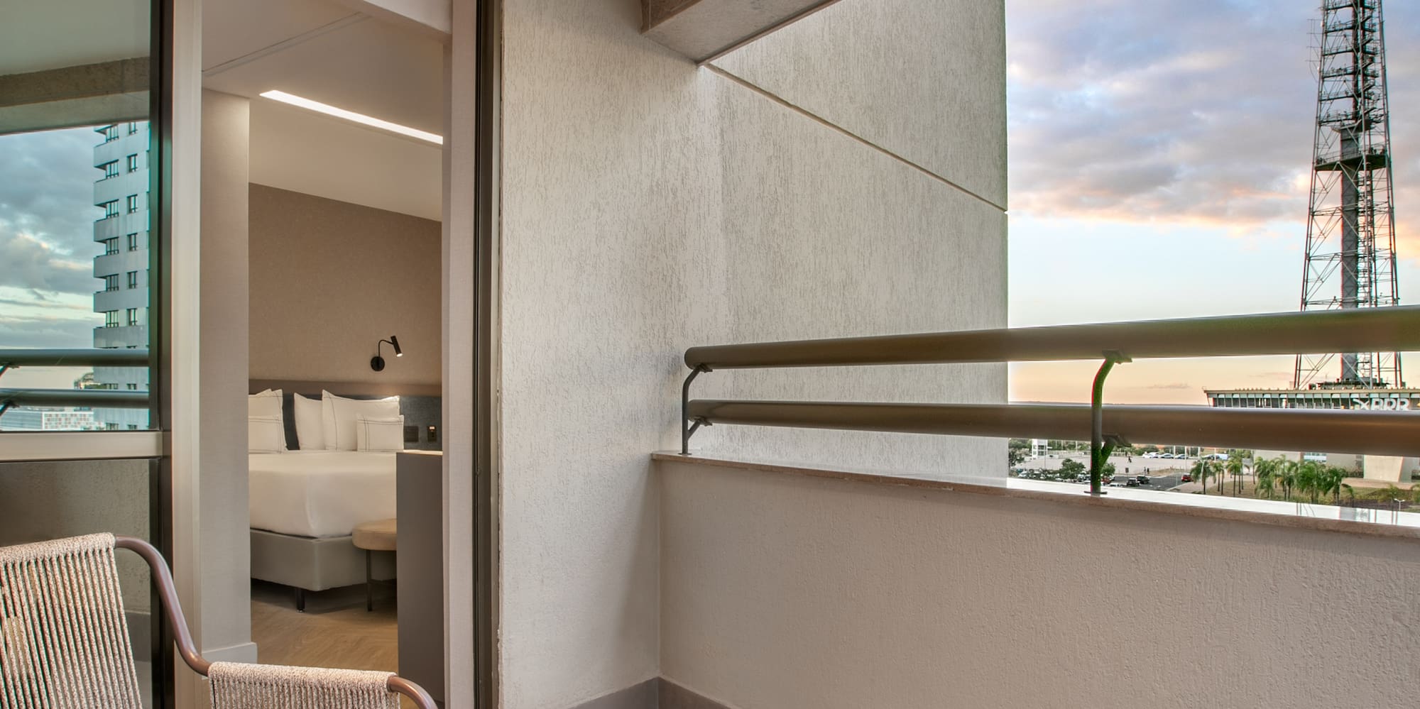 a balcony with chairs and a table