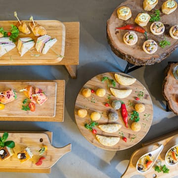 a group of wooden tables with food on them