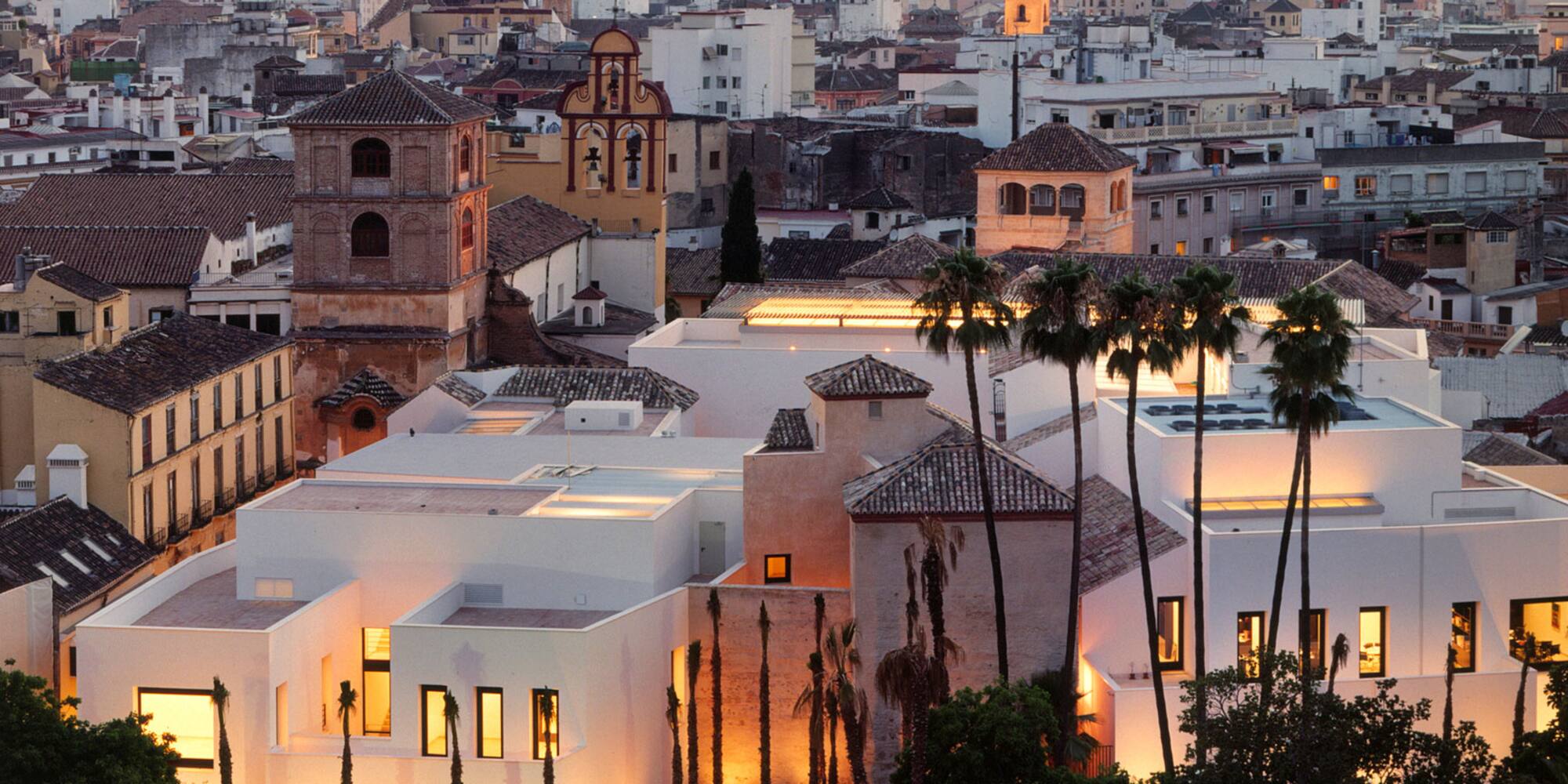 a group of buildings with palm trees