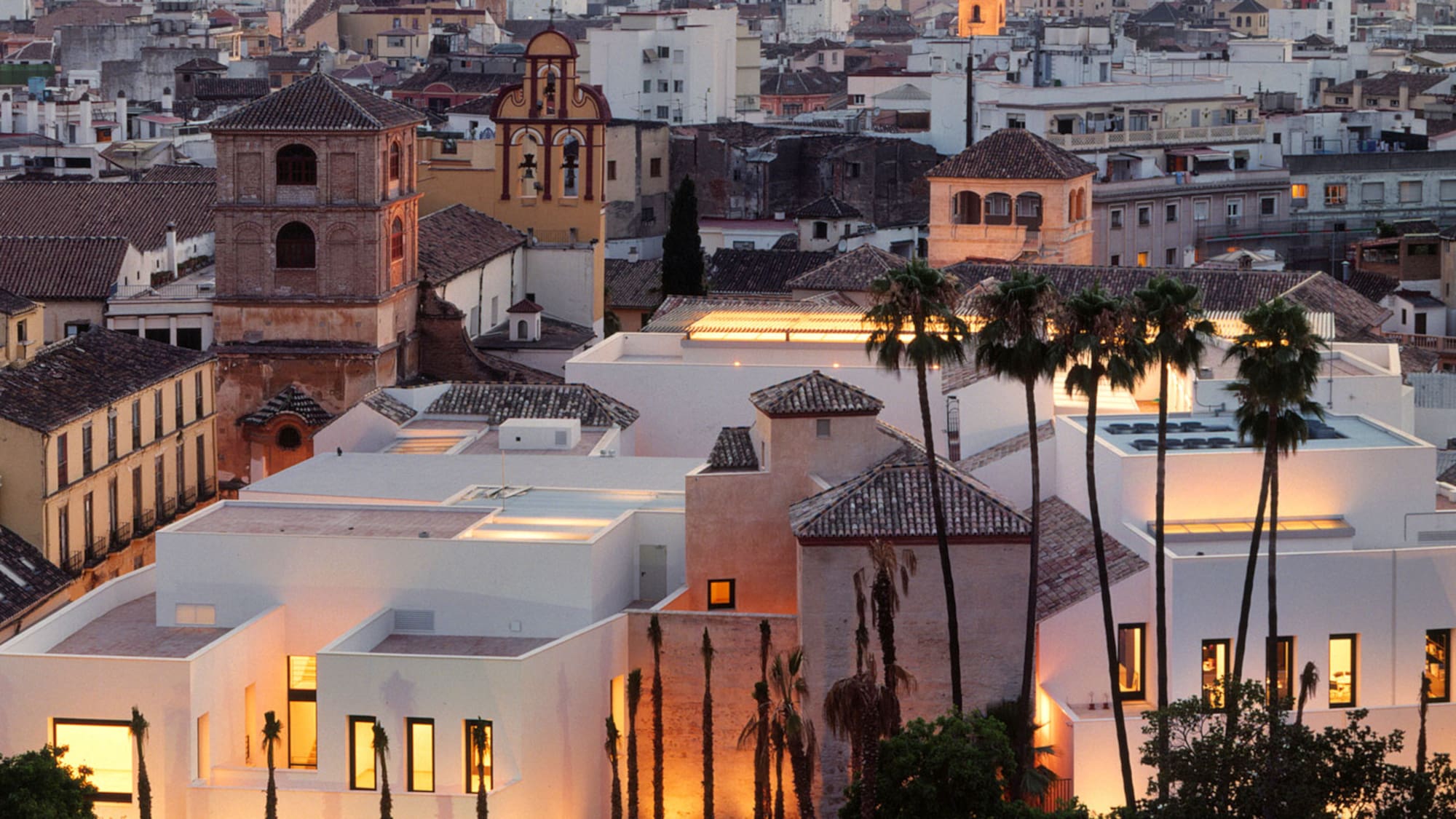 a group of buildings with palm trees