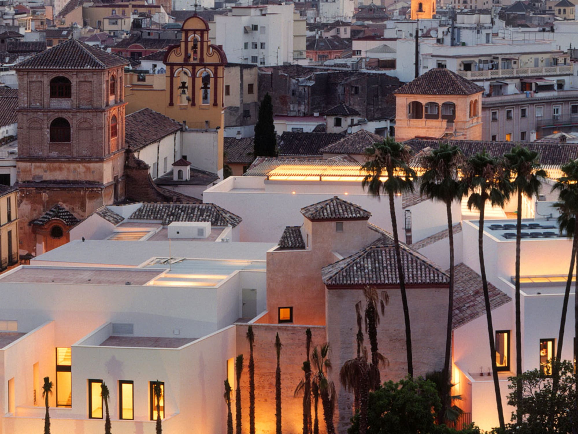 a group of buildings with palm trees