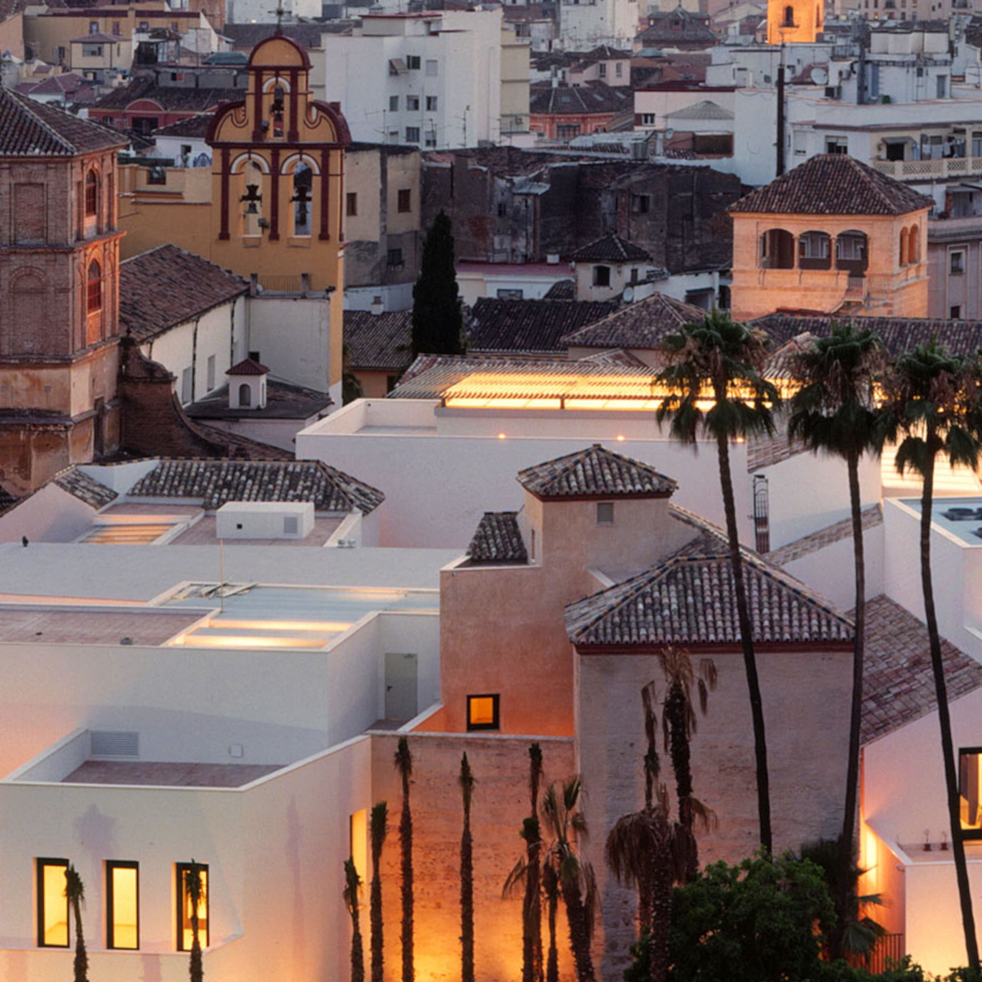 a group of buildings with palm trees