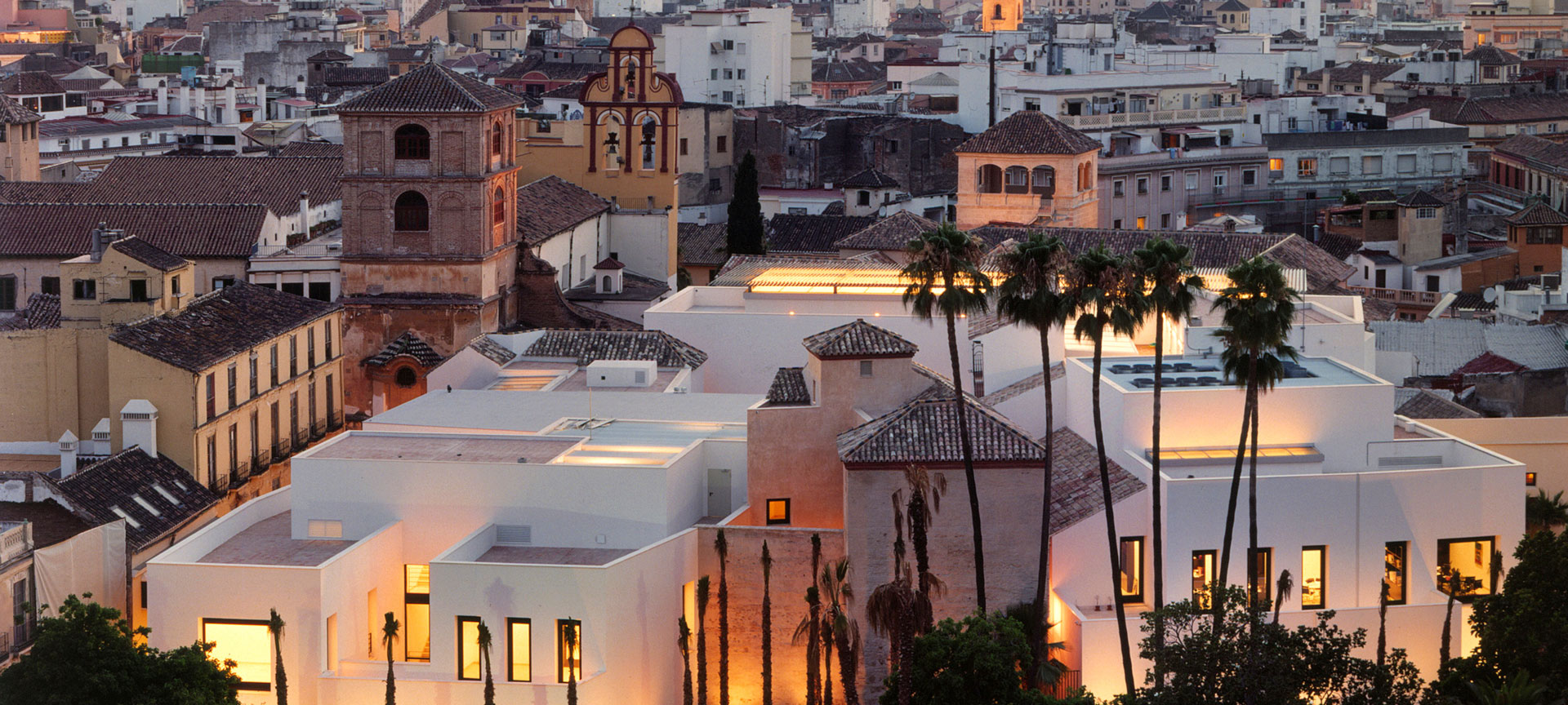 a group of buildings with palm trees