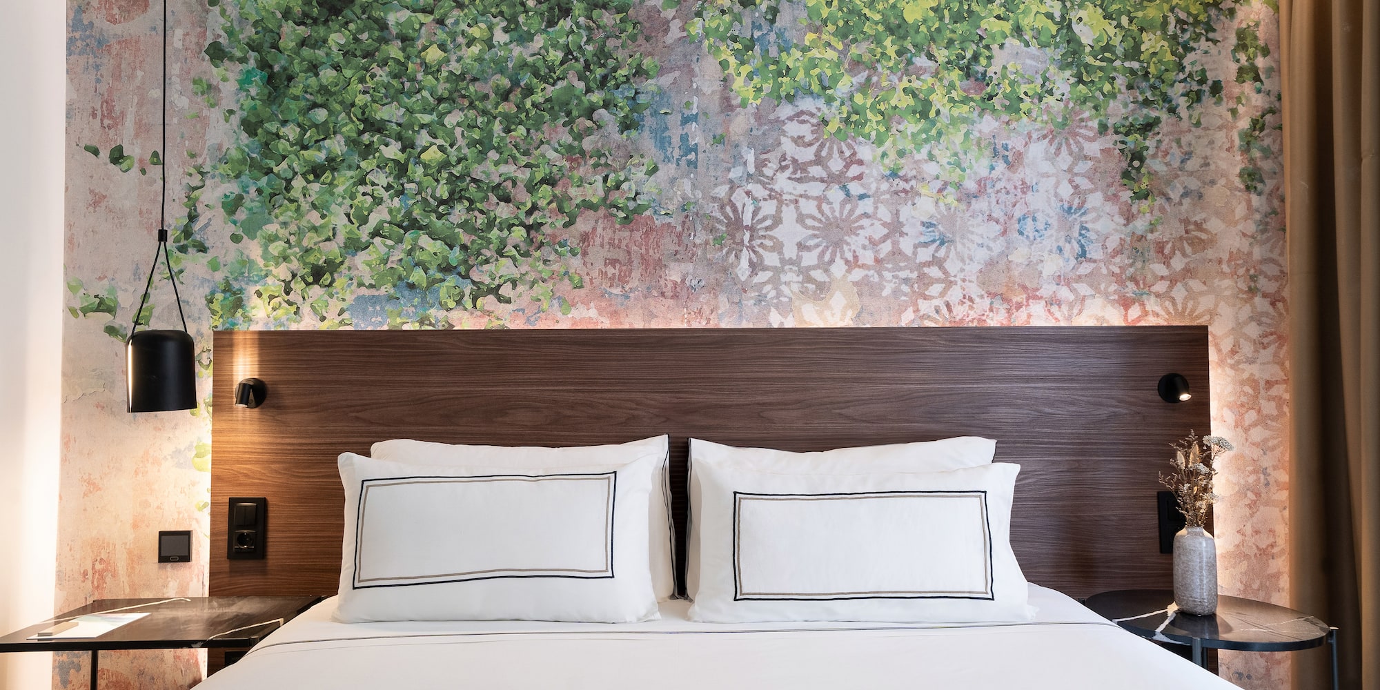 a bed with white sheets and a wood headboard