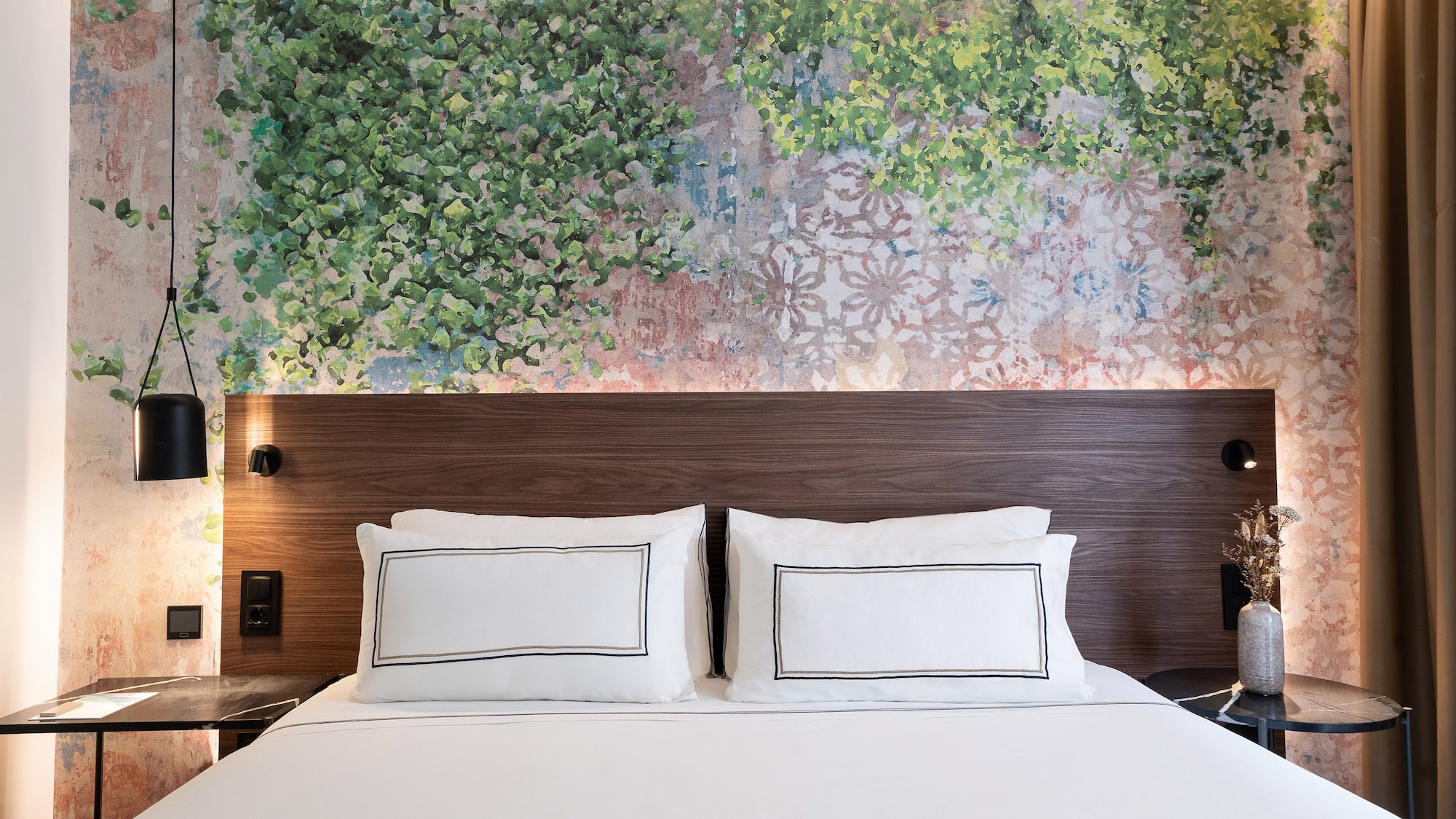 a bed with white sheets and a wood headboard