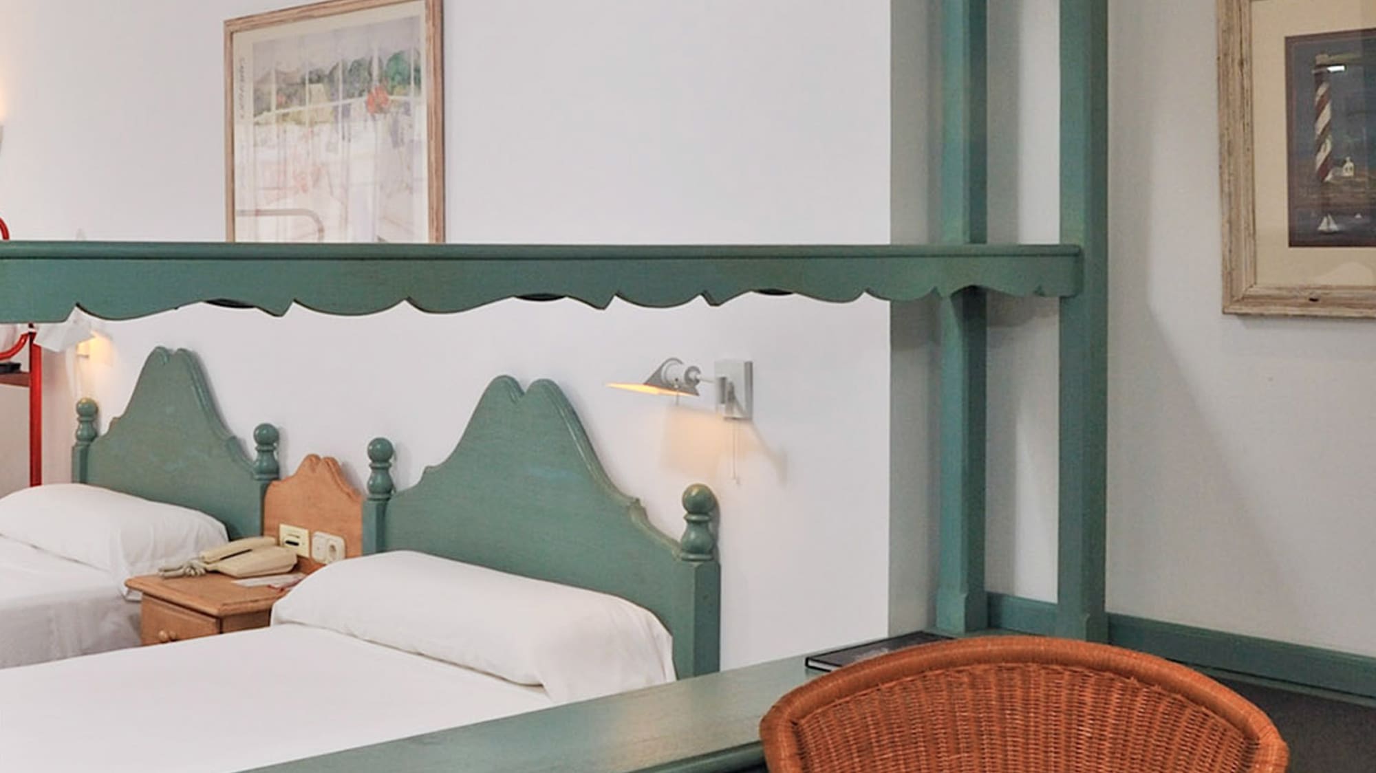 a room with two beds and a chair