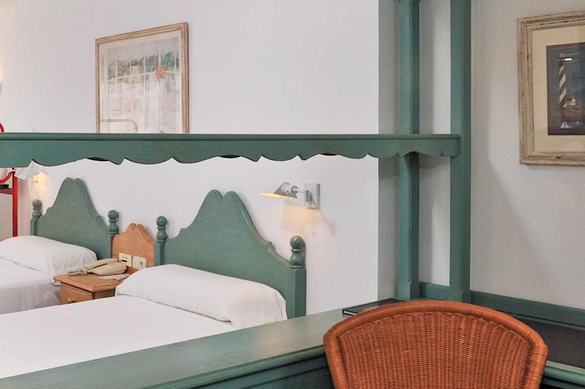 a room with two beds and a chair