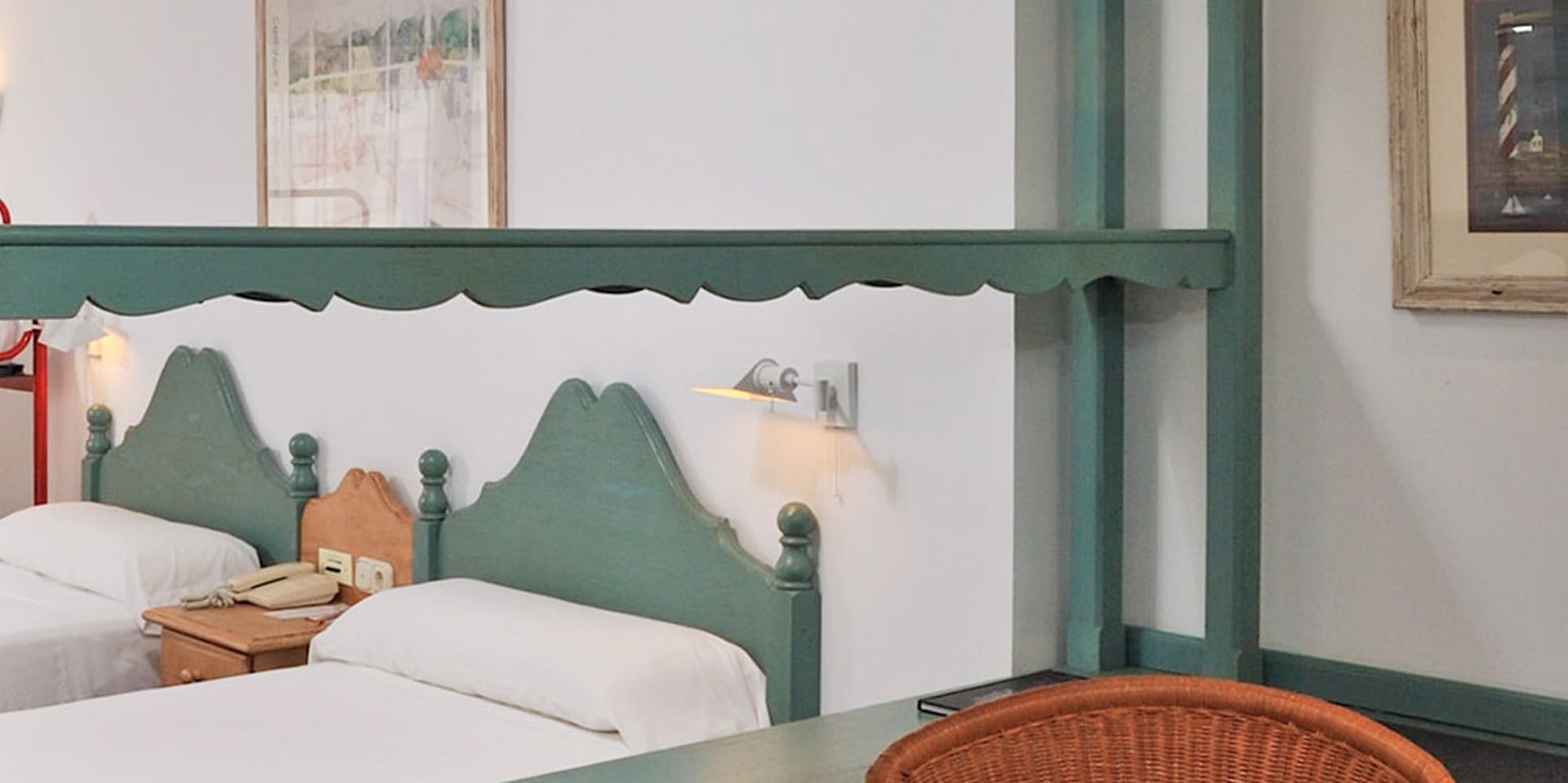 a room with two beds and a chair