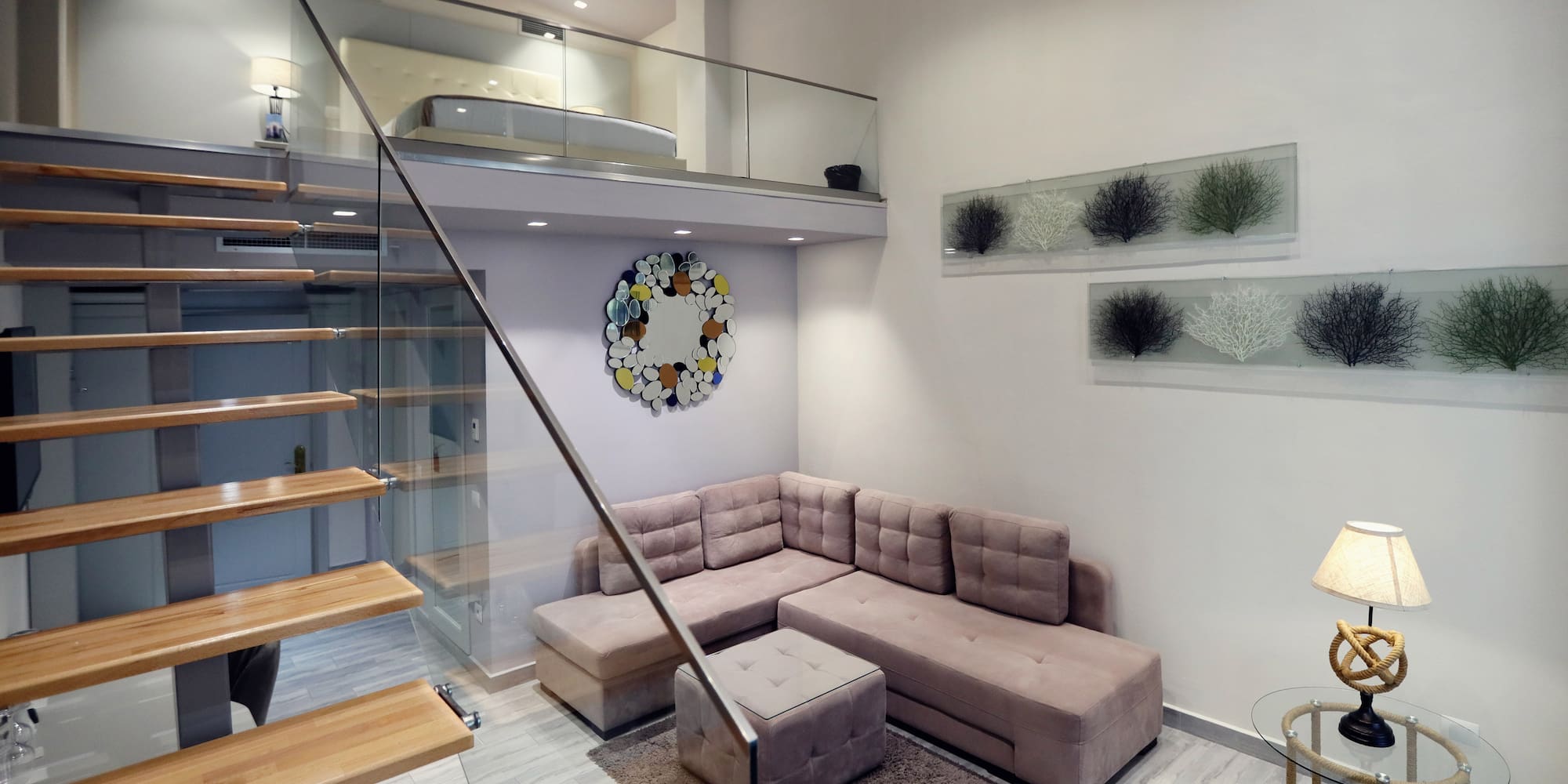 a living room with a couch and stairs