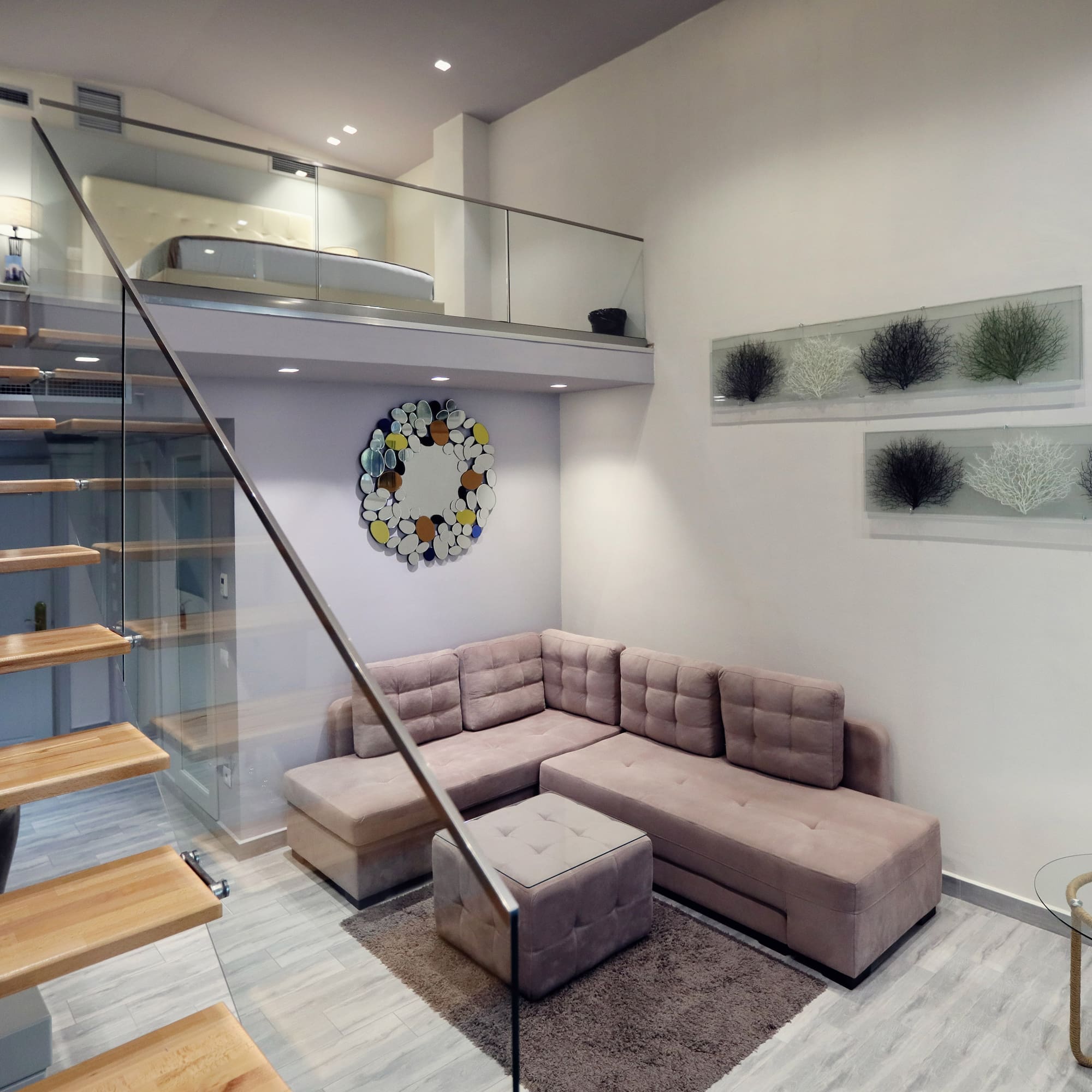 a living room with a couch and stairs