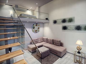 a living room with a couch and stairs