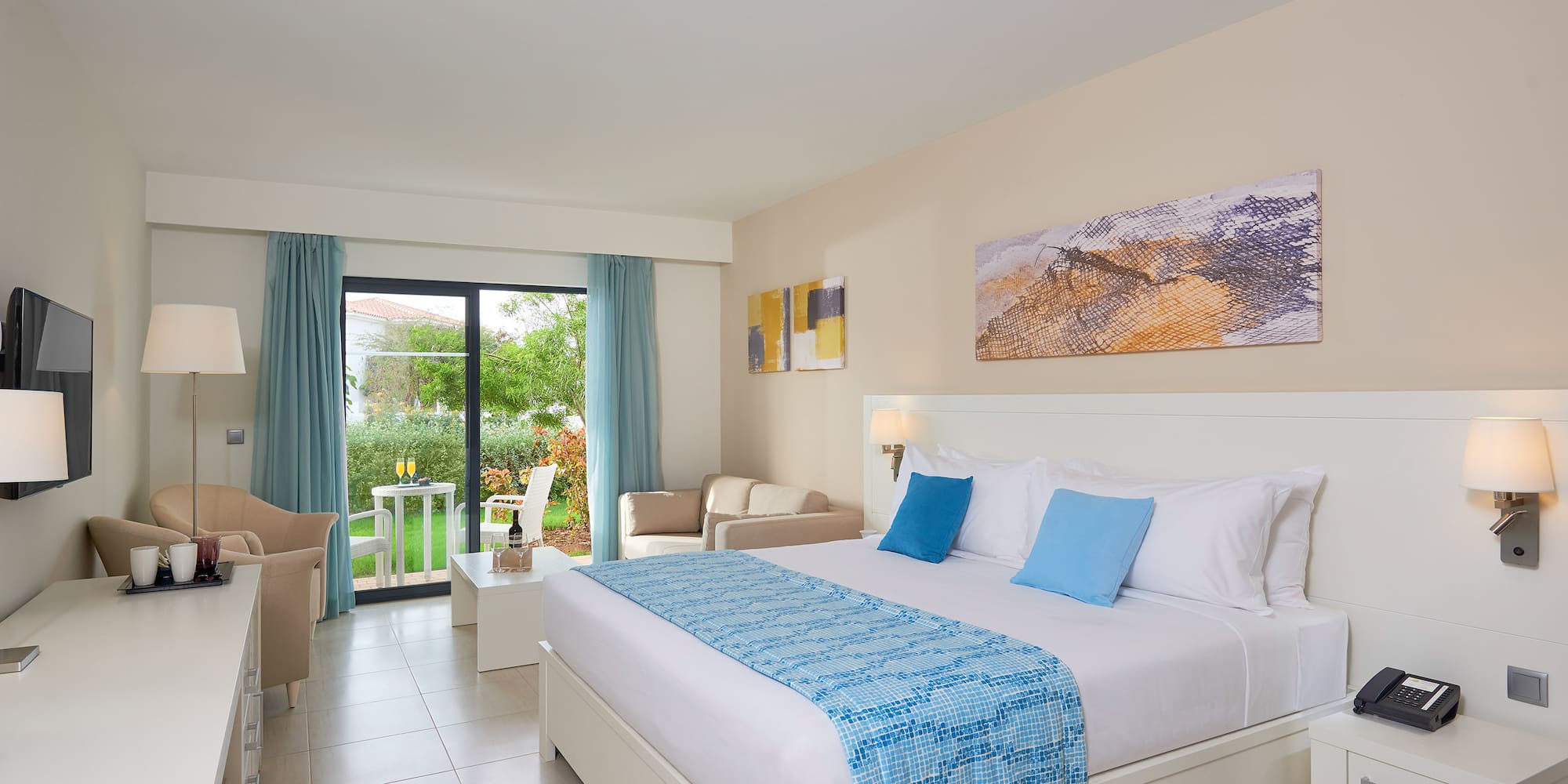 a bedroom with a bed and chairs