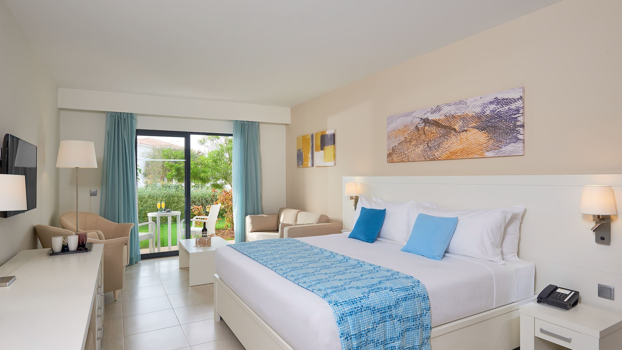 a bedroom with a bed and chairs