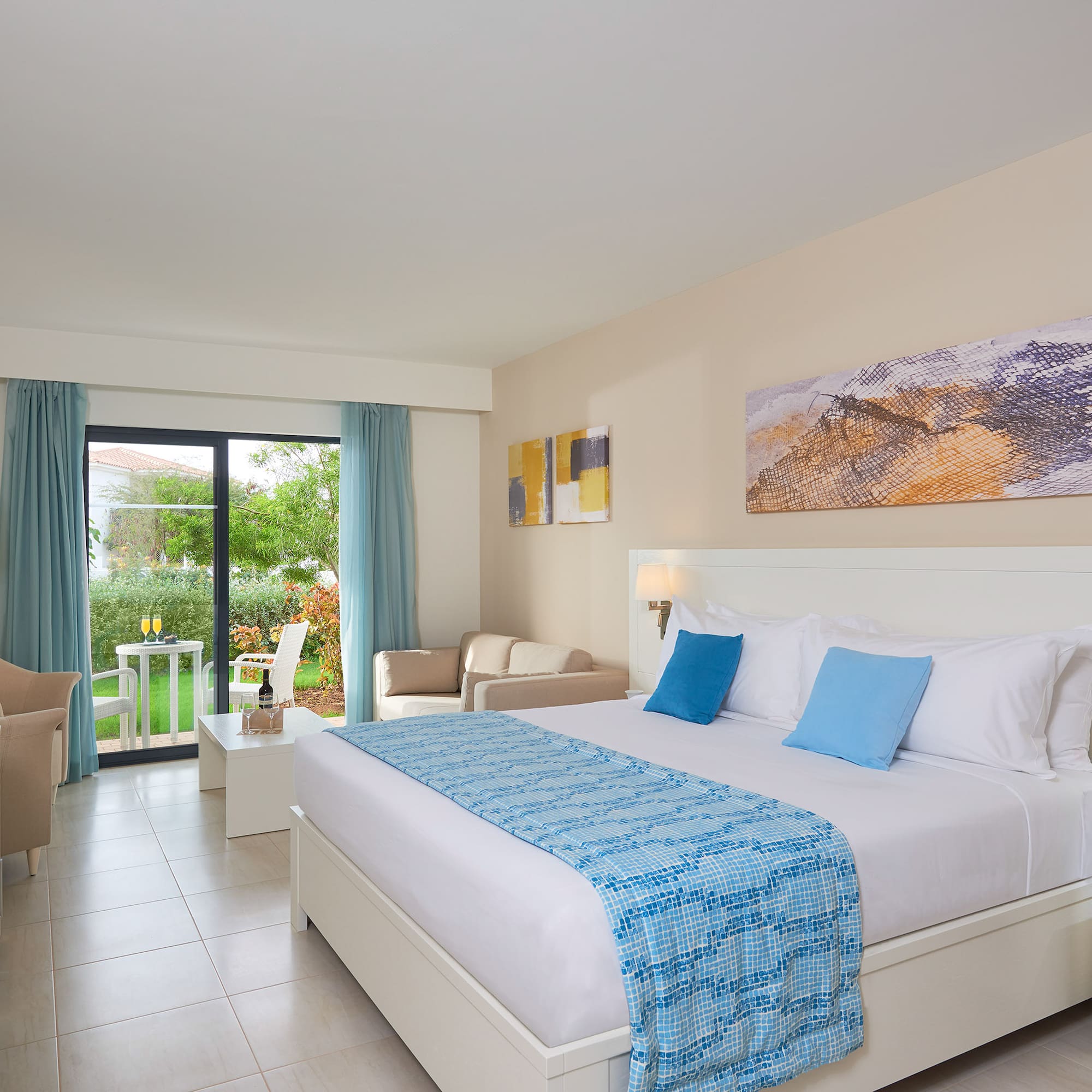 a bedroom with a bed and chairs