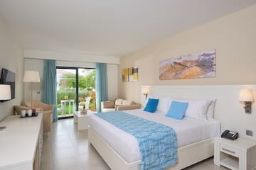 a bedroom with a bed and chairs