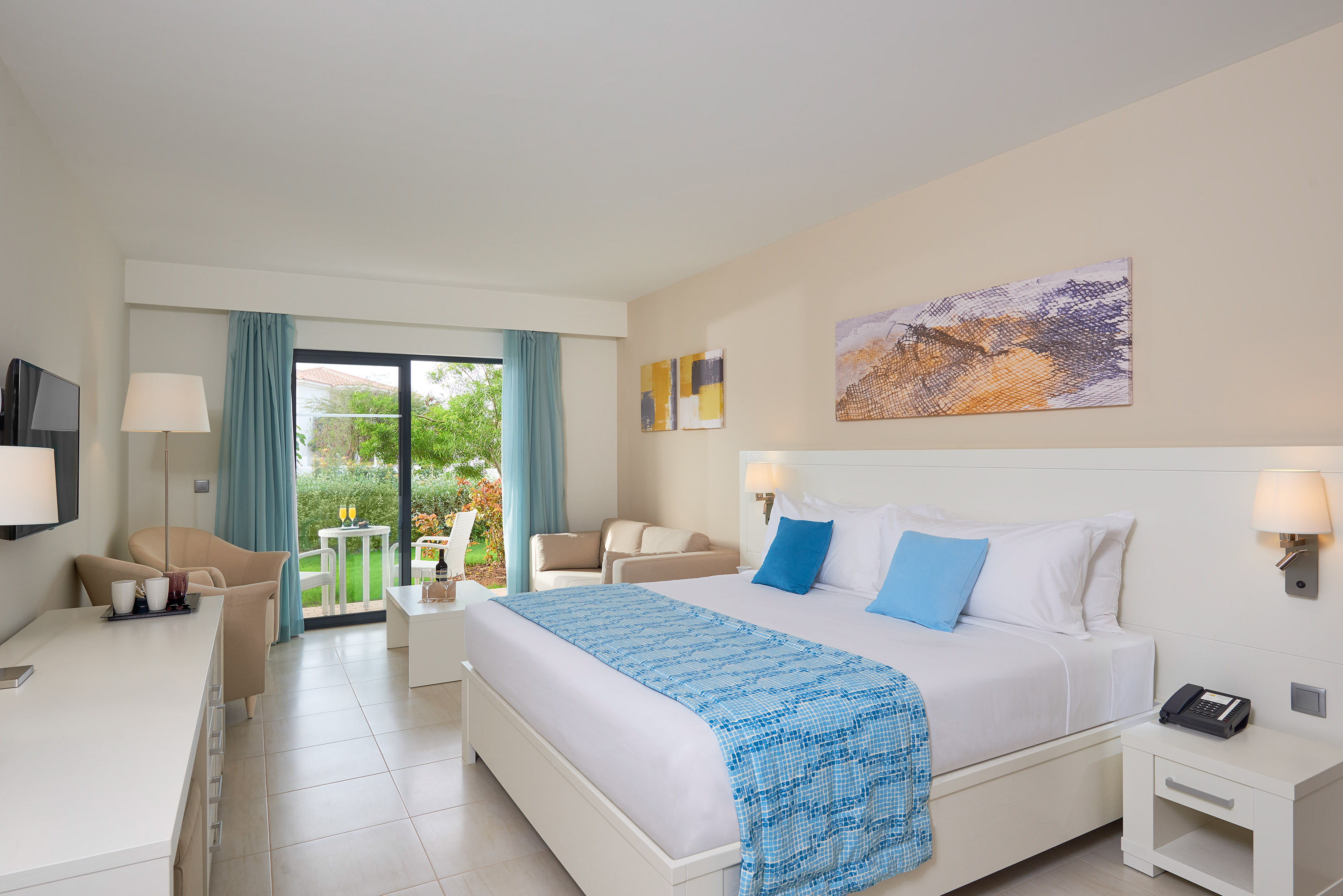 a bedroom with a bed and chairs