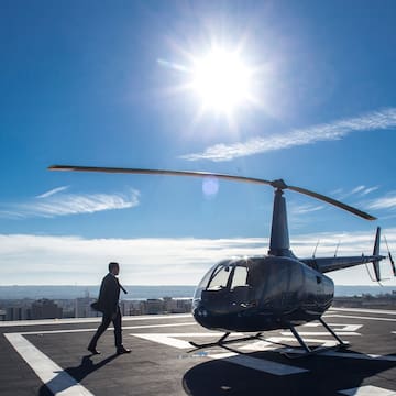 a man walking next to a helicopter