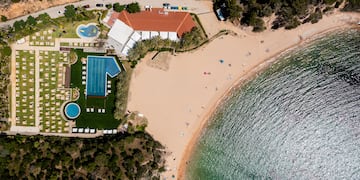 a beach with a swimming pool and a building