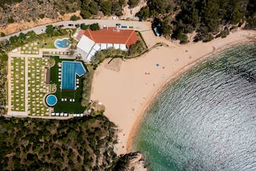 a beach with a swimming pool and a building
