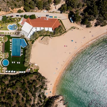 a beach with a swimming pool and a building