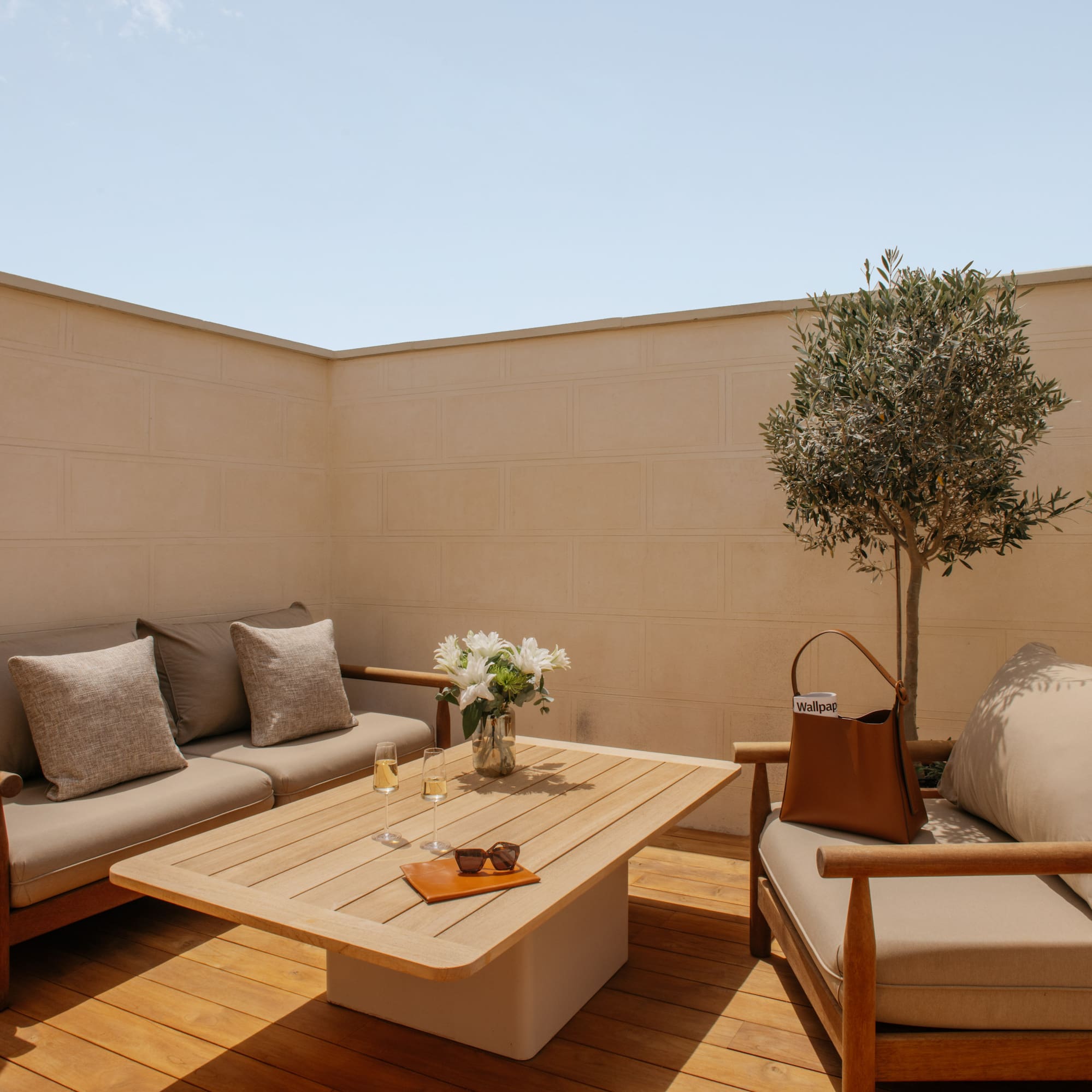 a patio furniture with a table and a tree